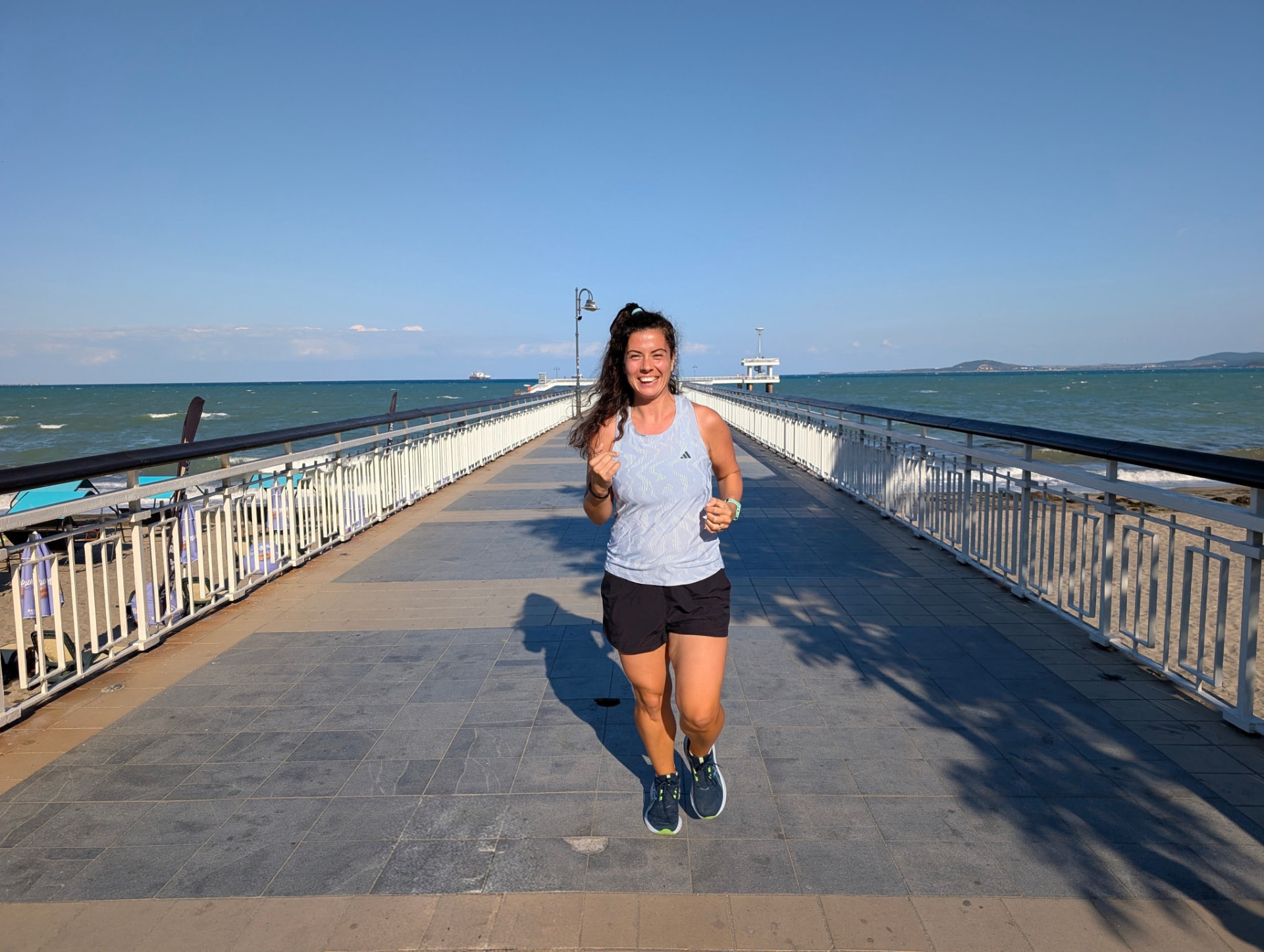 Runner on the Burgas pier over the sea
