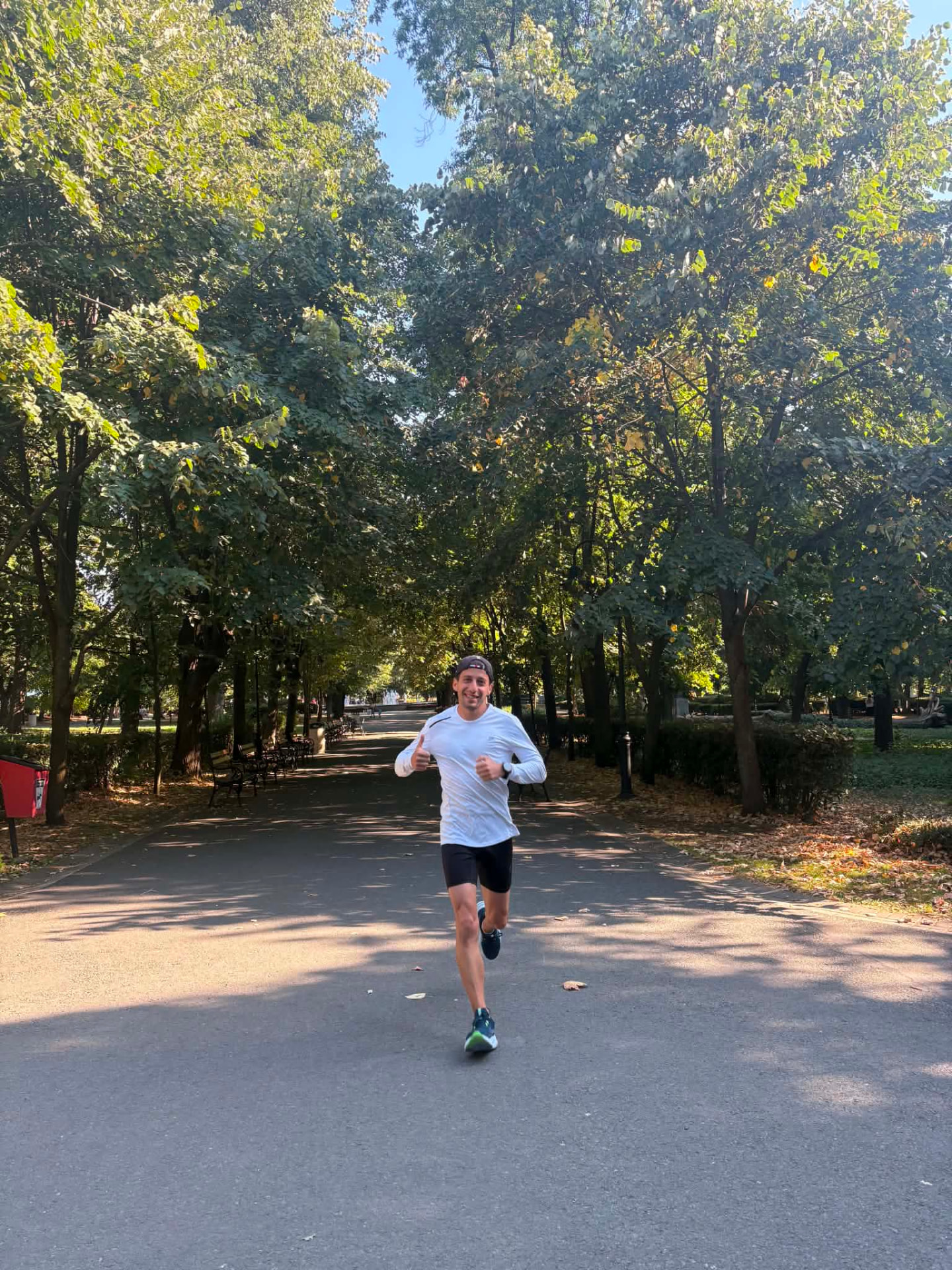 Runner on a shaded tree-lined alley in the Sea Garden